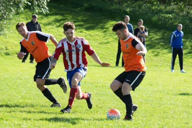 Edgehill, orange kit, in action during their 3-0 win at Hunmanby United