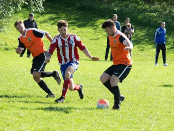 Edgehill, orange kit, in action during their 3-0 win at Hunmanby United
