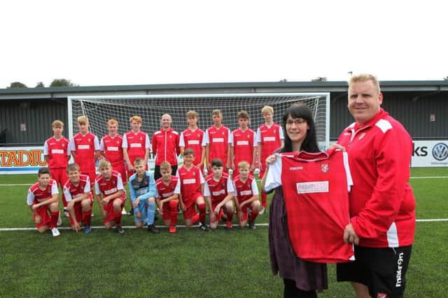 Asquith & Co director Jennifer Springham is pictured above presenting the new kit to coach Alec Coulson.
