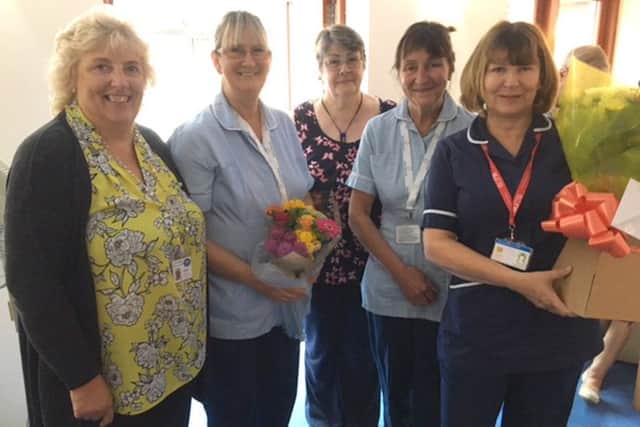 Diane Wingfield, second left, is presented with flowers and gifts as she ends her time at Saint Catherines Hospice.