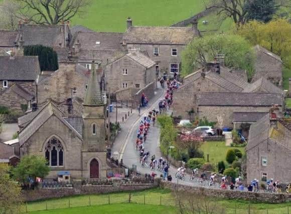 The Peloton passes through Burnsall in the Yorkshire Dales on the last leg of the race from Bradford to Sheffield this year. Picture: Tony Johnson