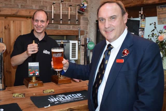 Brewery Manager Alex Balchin serves Paul Collingridge a pint of Remember