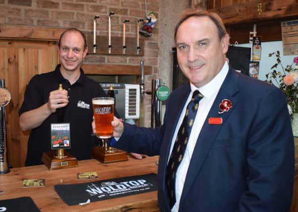 Brewery Manager Alex Balchin serves Paul Collingridge a pint of Remember