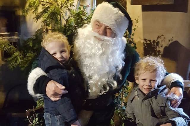 A traditional Santa dressed in green.