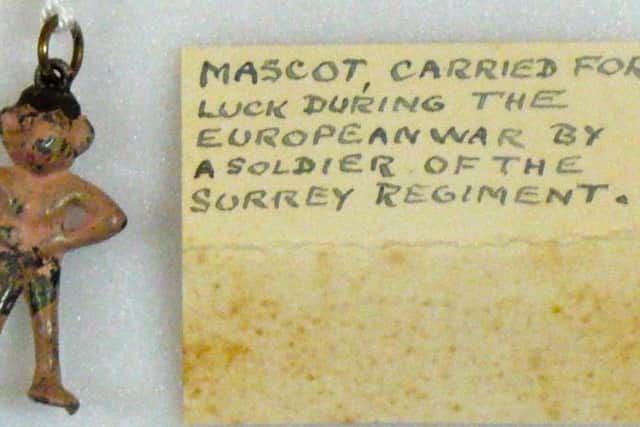 A First World War soldiers mascot worn to bring him luck, alongside Clarkes original label.
