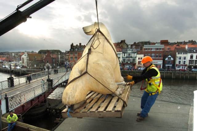 w064616b pic DJ
Snow Prince prepares to take his place as part of Whitby's spectacular Christmas decorations. Team Leader Steve Swalwell wrestles the Polar bear into position
