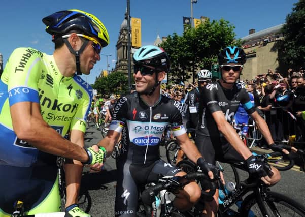 HE'S BACK: Mark Cavendish (centre) shakes hands with Alberto Contador (left) and Chris Froome at the start of of the first stage of the Tour de France n Leeds back in 2014. Picture: Bruce Rollinson