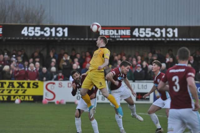 James Walshaw wins a towering header