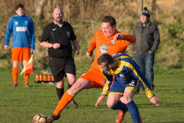 Scalby Reserves (orange) on the ball during their 9-1 hammering at Filey Town Reserves. Picture by Steve Lilly.