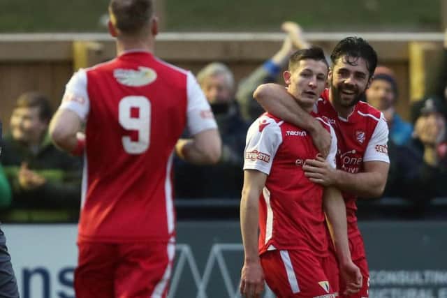 Max Wright celebrates a goal with Sam Hewitt