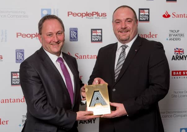 Tim Wilkins, left, CEO and Mark Carter of Dale PowerSolutions Ltd with the British Army accolade for Large Employer of the year Apprentice at the National Apprenticeship Awards.