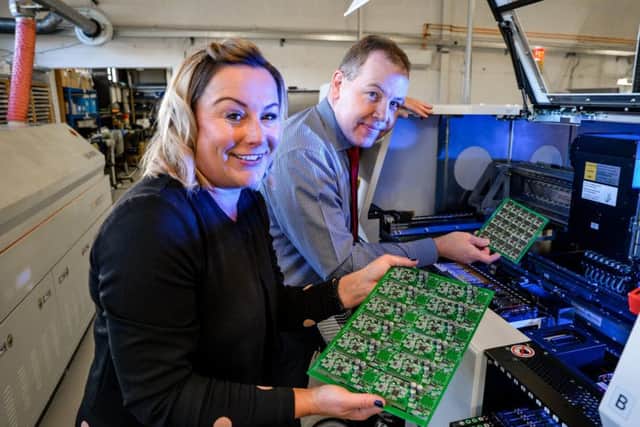 Contract Production managing director Simon Norris and sales manager Emma Wrigglesworth with some of the circuit board produced by the new £250,000 equipment.