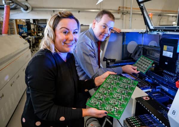 Contract Production managing director Simon Norris and sales manager Emma Wrigglesworth with some of the circuit board produced by the new Â£250,000 equipment.