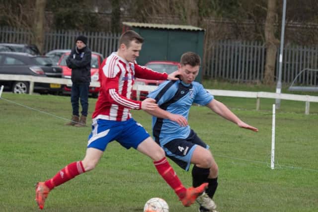 Hunmanby's James Pinder holds off a challenge from Ellery Liley.
SL-152323b