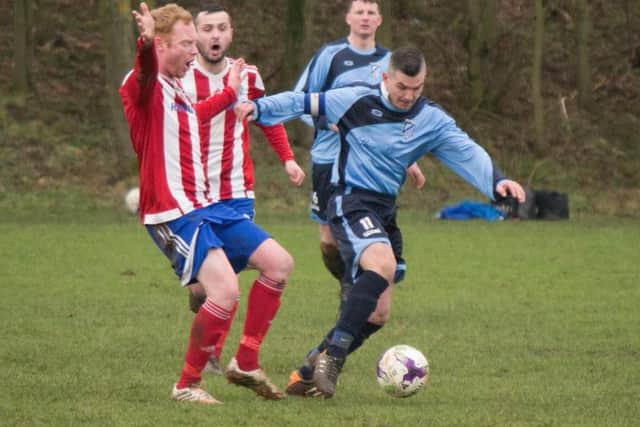 Filey Town in action during their 4-0 win at Hunmanby United (red and white stripes)