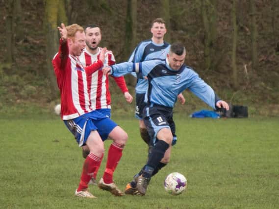 Filey Town in action during their 4-0 win at Hunmanby United (red and white stripes)