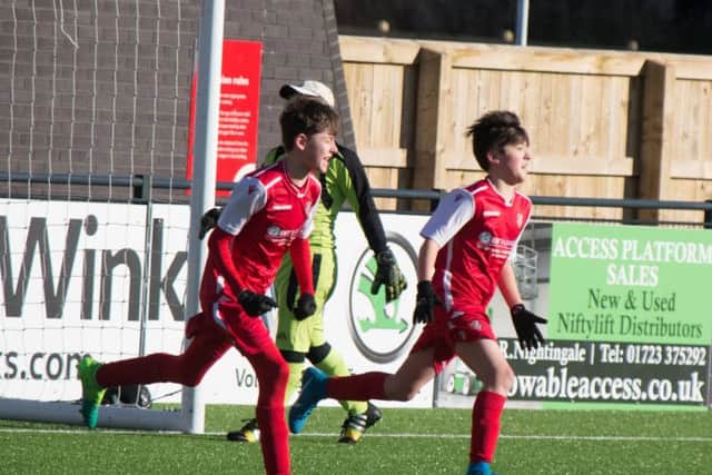 Scarborough Athletic Under-14s celebrate scoring in their resounding 11-1 win against Tickton Bulldogs at the Flamingo Land Stadium on Sunday 						                                Pictures by Steve Lilly