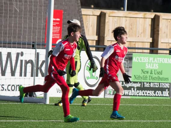 Scarborough Athletic Under-14s celebrate scoring in their resounding 11-1 win against Tickton Bulldogs at the Flamingo Land Stadium on Sunday 						                                Pictures by Steve Lilly
