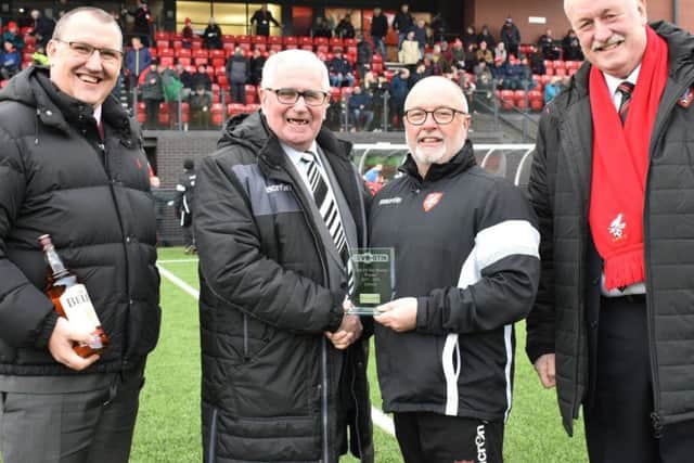 Boros Fred Firman, Steve Kittrick and Trevor Bull receiving the award from league representative Alan Ogley