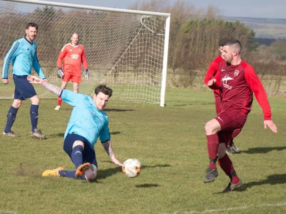 Castle Tavern's George Elliott makes a slide tackle against Angel Reserves


Picture by Steve Lilly
