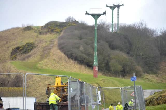 Workmen remove old chairlift pylon