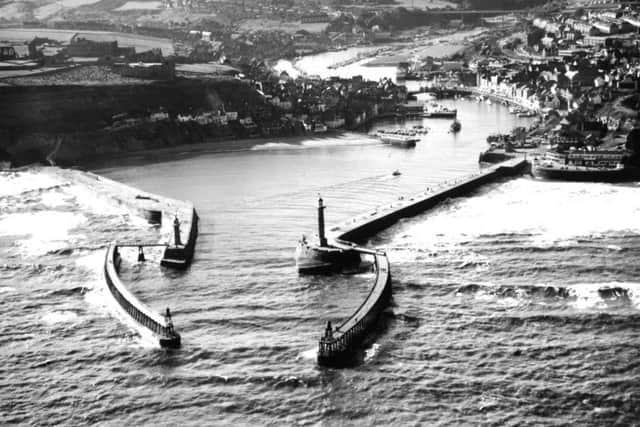 Aerial view of Whitbys two piers, harbour and river Esk as it disappears into the distance.