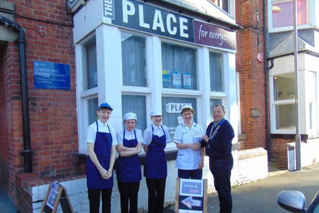 A cheque presentation to The Place Cafe on Brooklands.