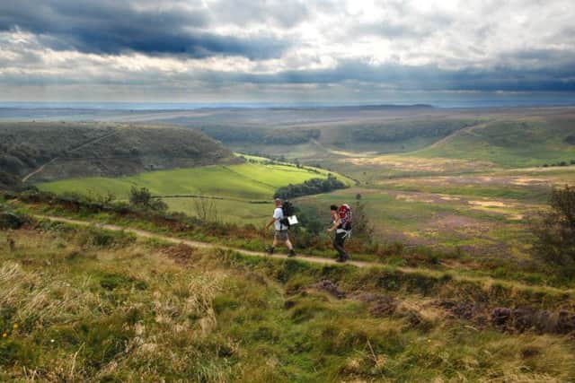 Walkers enjoy the view during their walk along the top of the Hole of Horcum.