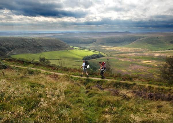 Walkers enjoy the view during their walk along the top of the Hole of Horcum.