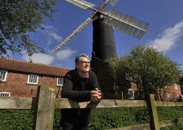 Skidby Mill windmill . Curator Richard Young at the mill