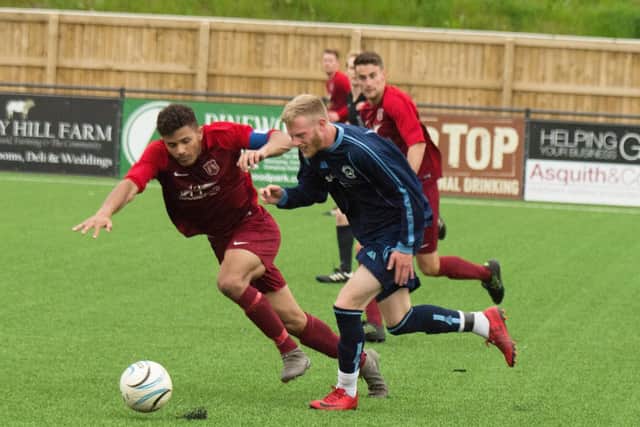 Pier's Rich Tolliday tries to get past Angel midfielder Lloyd Henderson