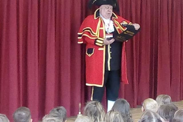 Town crier David Hinde speaks to the pupils at Helmsley Community Primary School.