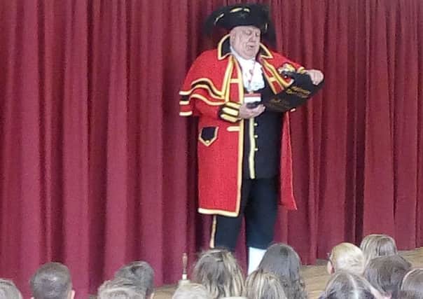 Town crier David Hinde speaks to the pupils at Helmsley Community Primary School.