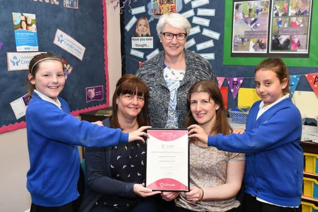 Hilderthorpe pupils Lyla and Libby, and headteacher Kath Carlisle congratulate Molly Fletcher and Gail Pugh.