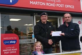 Chris Stanley from One Stop in Marton Road presents the cheque to Martin Barmby, a Royal Navy and 2nd Battalion Yorkshire Volunteers veteran representing the organisers Bridlington Veterans, and his daughter Isla.