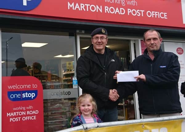 Chris Stanley from One Stop in Marton Road presents the cheque to Martin Barmby, a Royal Navy and 2nd Battalion Yorkshire Volunteers veteran representing the organisers Bridlington Veterans, and his daughter Isla.