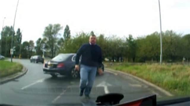 Deadman forces the victim's car door open and is seen punching the driver in the face (Photo: SWNS)