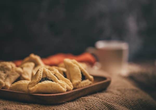 A traditional food served during Purim are hamantaschen, a triangular biscuit similar to a shortbread, typically filled with a sweet centre (Photo: Shutterstock)